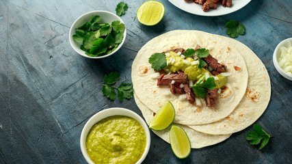 Carne Asada Tacos with grilled steak, green sauce and onion. Mexican food