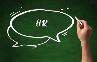 Hand drawing HR abbreviation with white chalk on blackboard