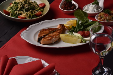 grilled fish with french fries and vegetables