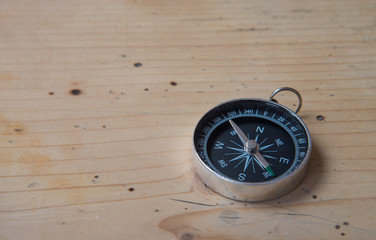 Compass on wooden table