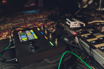 Electric guitar and guitar audio processing effects on a studio floor. Electric guitar and stomp...