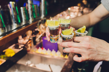 Hand holding a glass with vodka shot.
