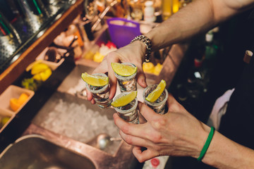 Hand holding a glass with vodka shot.
