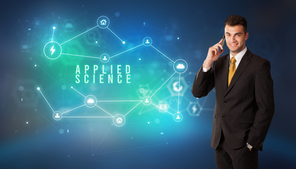 Businessman in front of cloud service icons with APPLIED SCIENCE inscription, modern technology concept