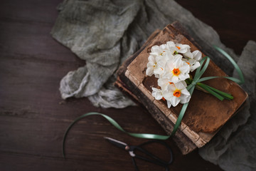 Small Bouquet of Paperwhite Nacissus tied with Green Ribbon on Vintage Books