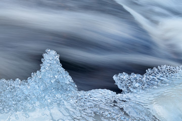Bond Falls rapids captured with motion blur and framed by ice, Michigan's Upper Peninsula, USA