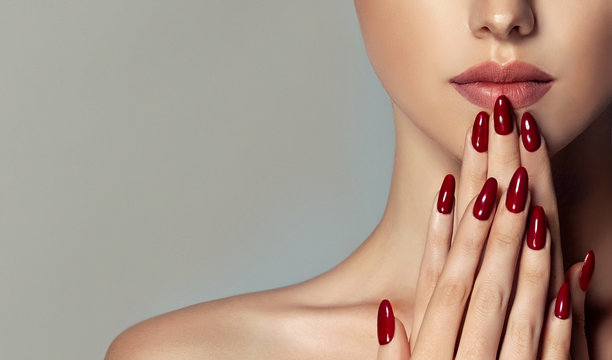 Beautiful girl   . Model woman showing  red  shellac manicure on nails   . Cosmetics ,beauty and makeup