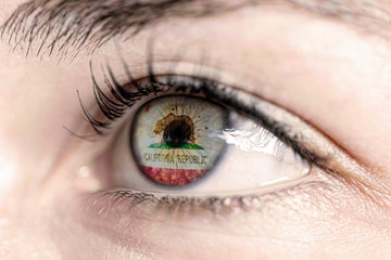 Fototapeta na wymiar Flag of california state of the United States of America reflects in a man brown eye - election, sport, hope, young, generation, american football, basket 