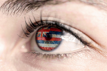 Fototapeta na wymiar Flag of hawai state of the United States of America reflects in a man brown eye - election, sport, hope, young, generation, american football, basket 