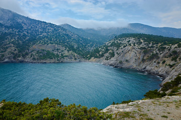 Fototapeta na wymiar Blue Bay in the New World Botanical Reserve, the eastern coast of the Crimea Peninsula. Mountains by the Black Sea, view from Cape Kapchik.