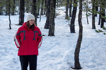 Young happy and beautiful teenage standing at snow and smiling.