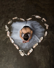 Woman inside heart made of ballet pointe shoes © ilyaska