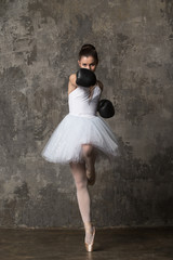 Concept of strong and feminine woman - ballerina fighting in white costume and boxing gloves © ilyaska