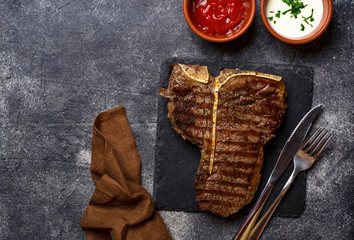 Grilled T-bone steak on dark background