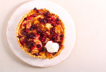 Apple and berry tart on board