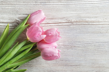 Tulips - bouquet pink tulips on wood background