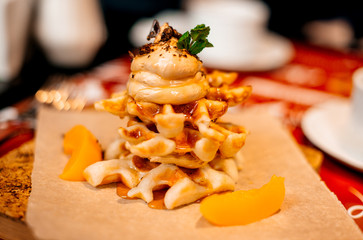 Belgian waffles for breakfast. Waffles with whipped cream, caramel sauce and fresh fruit