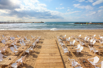 Seaside outdoor empty cafe by the beach. Beautiful calm blue sea and free sand beaches....