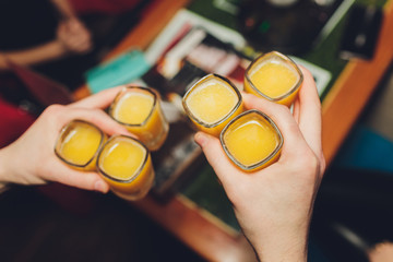 Hand holding a glass with vodka shot.