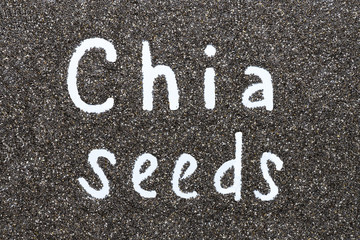 Written word Chia Seeds on a background of seeds top view