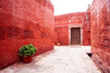Terracotta walls of buildings monastery of Santa Catalina, Arequipa, Peru, old wooden door.