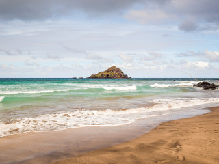 Fototapeta premium Koki Beach Park Maui. The dark red sand at Koki Beach was produced by the nearby cinder cone hill of Ka Iwi O Pele. Koki Beach is one of two famous Hana surf breaks and favorite spot for local surfers