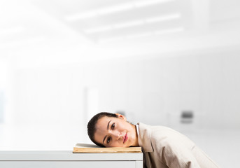 Bored business woman lying on desk