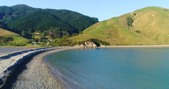 4k forward tracking aerial of the natural boulder barrier causeway beside the sea connecting Pepin island with south island at the picturesque area known as Cable Bay,Rotokura,South Island New Zealand