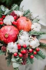 Winter bridal bouquet with garnet and green tree