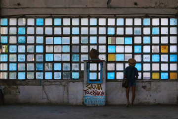 Old factory windows with woman looking