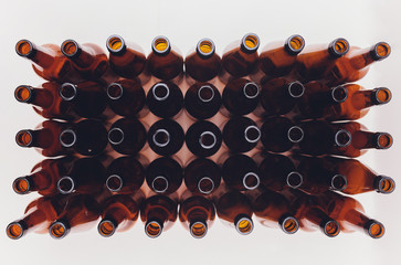 Close-up of beer bottles, focus on middle one, isolated on white background.