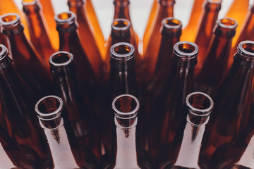 Close-up of beer bottles, focus on middle one, isolated on white background.