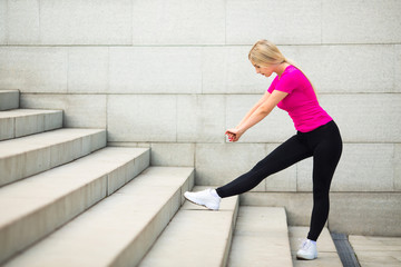 beautiful young woman in sportswear in the summer on the street