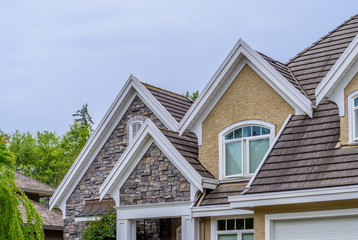 The top of the house or apartment building with nice window.