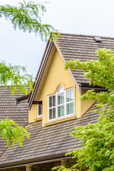 The top of the house or apartment building with nice window.