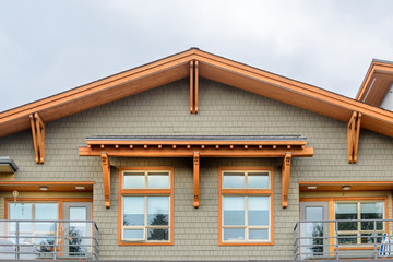 A perfect neighborhood. Houses in suburb at Summer in the north America. Top of a luxury house with nice window over blue sky.