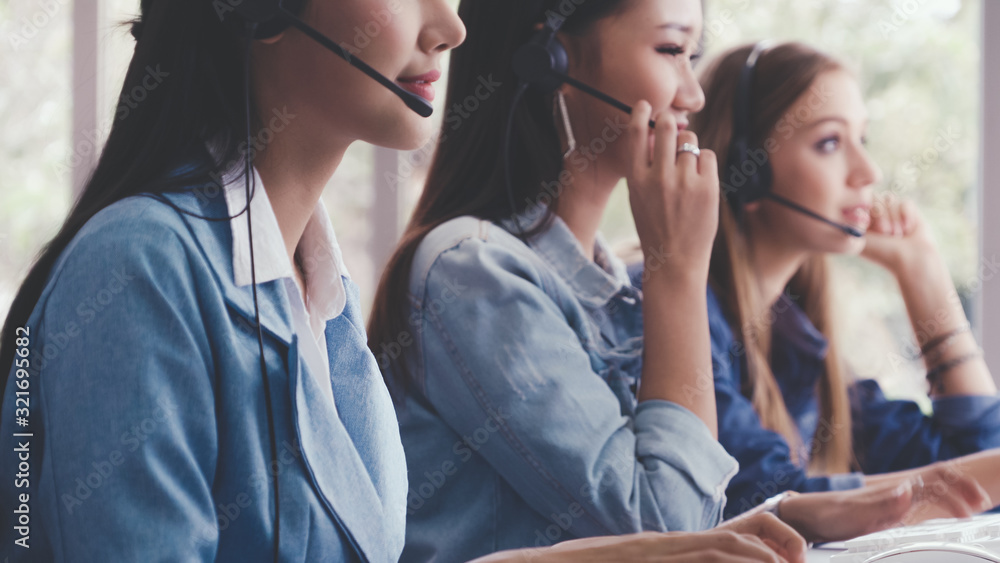 Aufkleber customer support agent or call center with headset works on desktop computer while supporting the cu