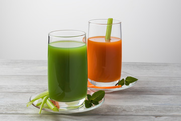 Fototapeta premium Homemade vegan green juice with vegetables, carrots, celery and herbs. Antioxidant drink