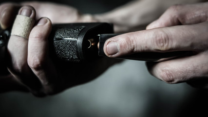 Fototapeta premium Man loading a pistol with hollow point ammunition.