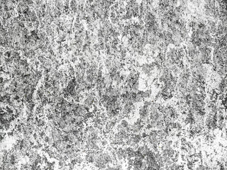 Grey-white concrete wall with many surface shapes due to condensation and splashes.