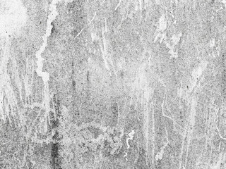 Grey-white concrete wall with many surface shapes due to condensation and splashes.
