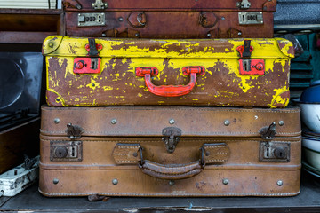 Stacks of old metal suitcases at a flea market in Malang, Indonesia.