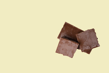 spoiled broken chocolate bar covered with white coating on an isolated light background. greasy chocolate