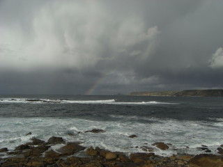 Stormy sky with rainbow from Lands End, over Sennen cove, Penwith, Cornwall