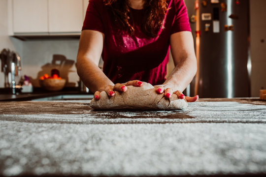 .Young Woman Kneading Bread In Her Home Kitchen. No Culinary Skills And All Flour Stained In The Kitchen. Having Fun. Close Up. Lifestyile