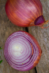 Red large onion cut on a wooden Board.Photo.