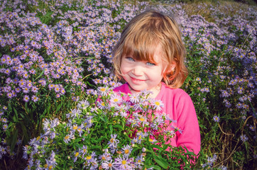 beautiful girl picking flowers for her mom