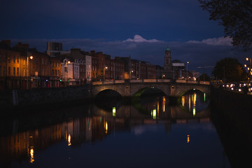 Dublin's night cityscape with bridge over Liffey river