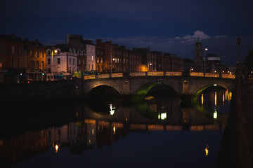 Dublin's night cityscape with bridge over Liffey river