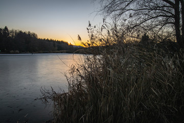 scenics sunset in winter season on a frozen lake